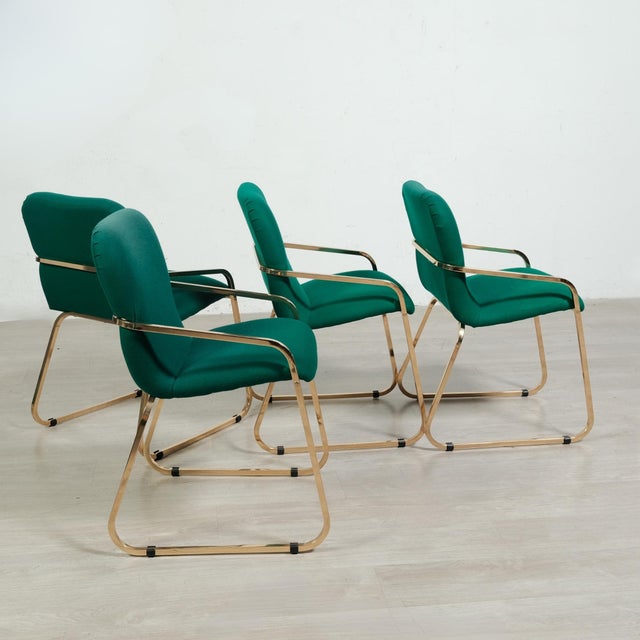 Set of 4 elegant chairs/armchairs with gold-colored chromed metal frame, seat and backrest covered in green fabric....