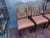 Each measures 41 1/2" high x 22" deep x 20 wide, seat height 21". Chairs have leather seats and hand-carved backs. Leather...