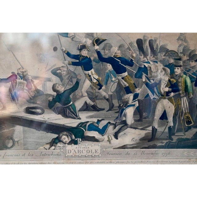 This historic color lithograph depicts Napoleon Bonaparte on the first day of the Battle of the Arcole Bridge. Based on an...