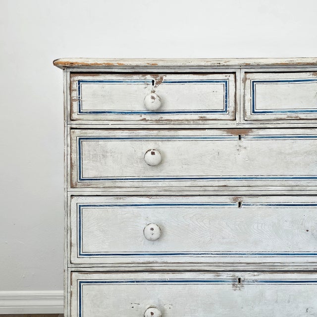 Dimensions: 40.25"W x 19"D x 36"H A beautiful late 19th-century pine dresser. Painted in a soft cream color and accented...