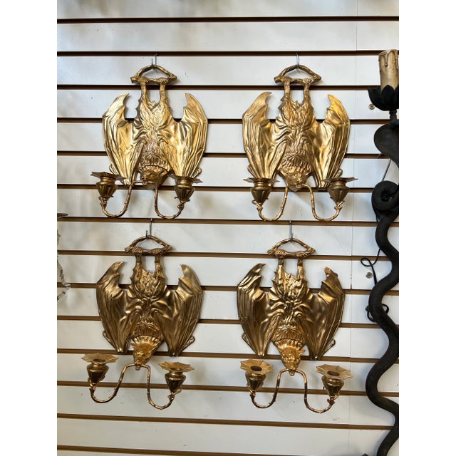 Introducing a truly captivating and unique pair of bronze guilt bat sconces, skillfully crafted to add an intriguing touch...