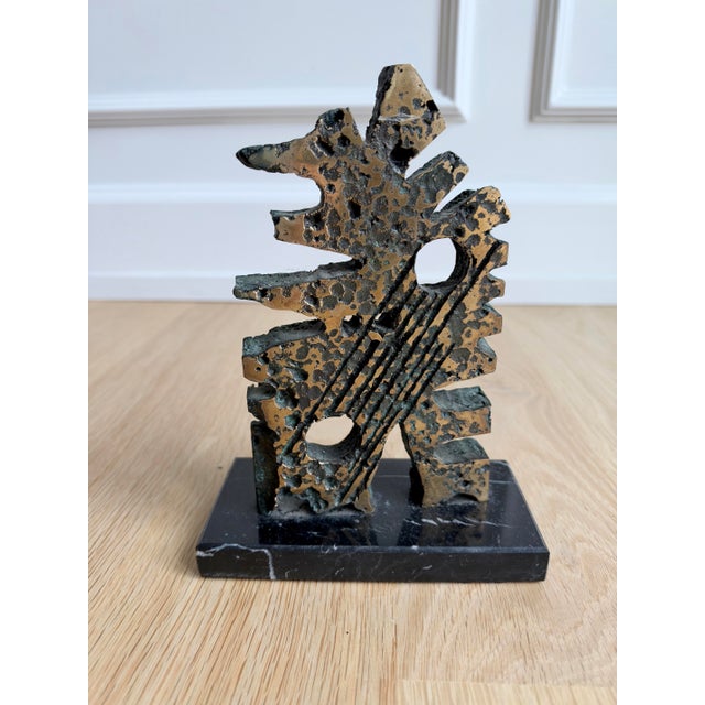 Signed vintage abstract sculpture executed in solid cast bronze and mounted on a black marble base. The compact work has...