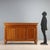 Empire-style walnut sideboard. Three-door paneled front, turned half-column uprights with carved and gilded pastiglia...