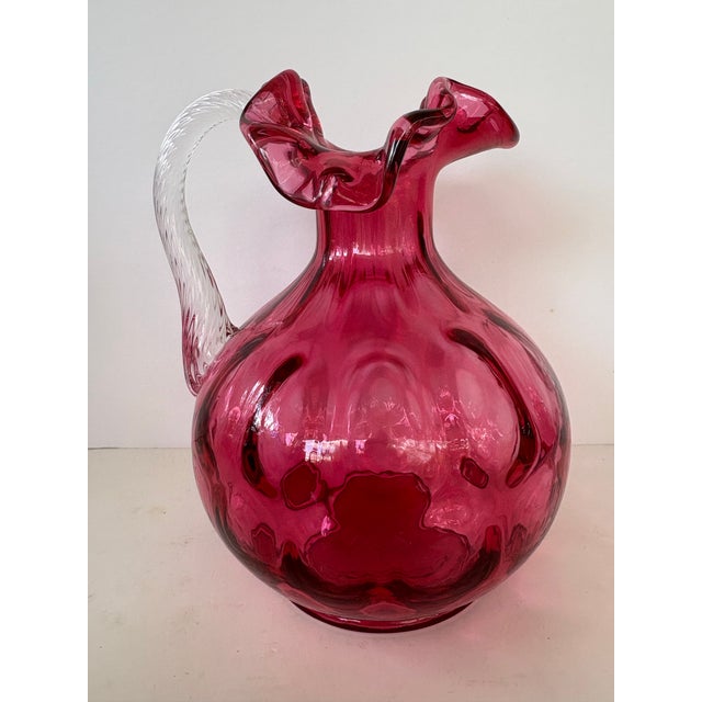 This vintage Fenton Art Glass pitcher is crafted in richly saturated cranberry glass and features the classic Dot Optic...