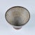 Stoneware chalice bowl with drip glaze. The piece features a pedestal base with a rust and black drip glaze and white...