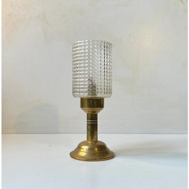 In the style of Hans Agne Jakobsson comes this stylish oil lamp fashioned from solid patinated brass and featuring and...