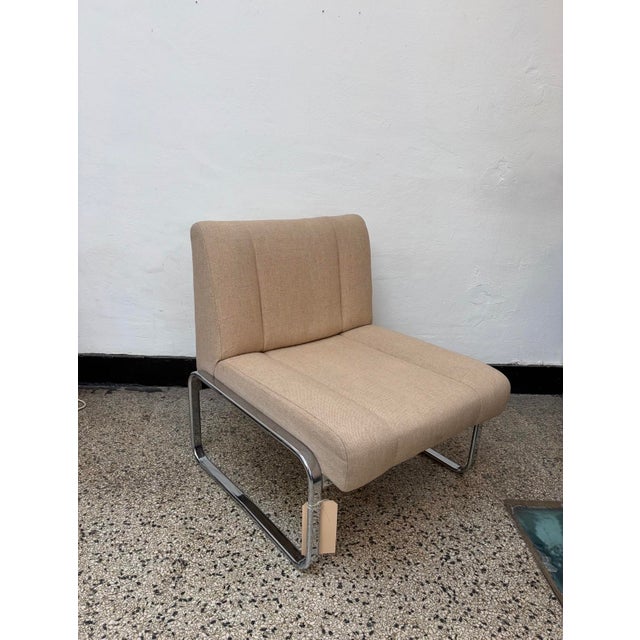 Elegant upholstered cantilever lounge chair dating from approximately the 1970s. The chair features a sculptural tubular...