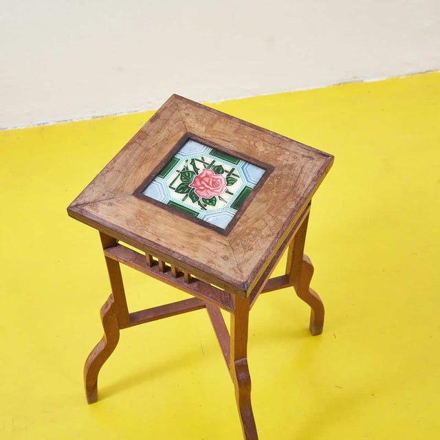 This antique coffee table is a rare combination of style and craftsmanship. The finely crafted wooden frame features an...