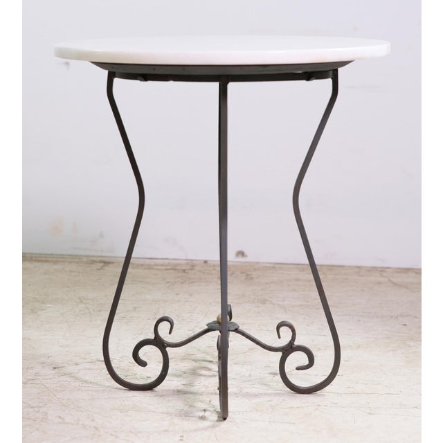 Vintage wrought iron side table with a newly installed, still antique, white marble top. The scrolled iron legs pair...