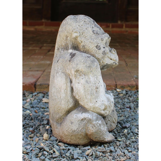 Mid-20th century cast stone seated gorilla garden ornament, English. He is a happy Silverback smiling with his banana in...