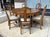 This seven-piece antique oak dining set, crafted by J.B. Van Sciver Co. in Camden, NJ, includes a substantial round table...