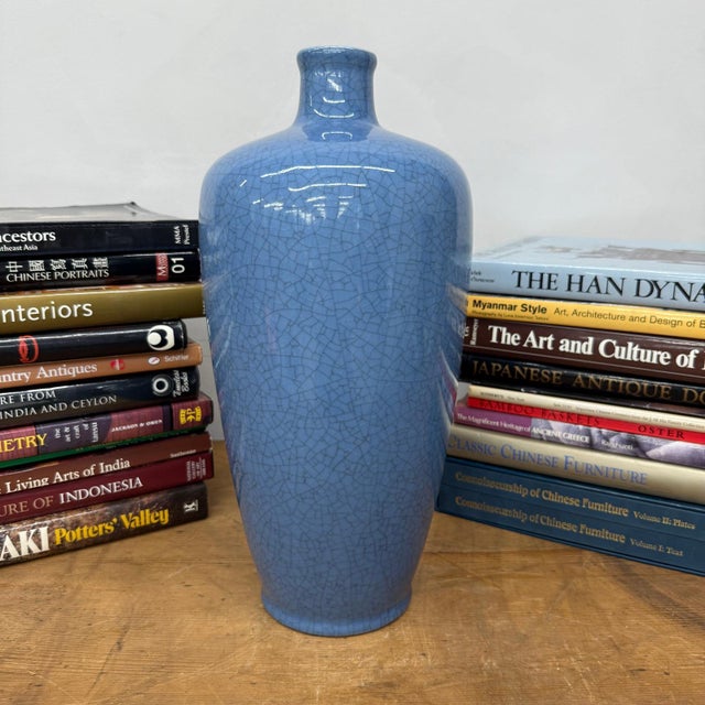 "About This Piece About This Piece This striking vase draws the eye with its luminous blue glaze, layered with a fine...