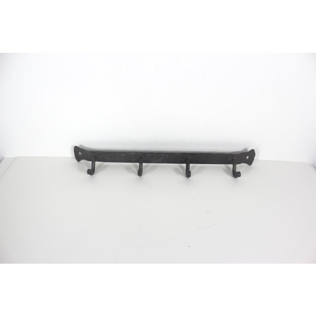This is a very useful vintage hand forged iron rack with 4 hooks. The ends of the hooks are curled. Perfect for front...