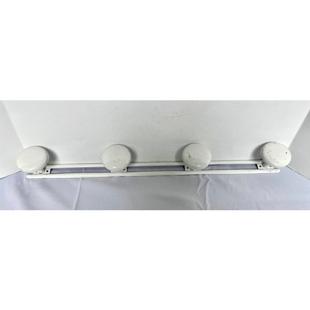 Sourced in Avignon France. Mid-Century french enamel four peg coat rack. Sleek classic design. Use in a mudroom or entry...