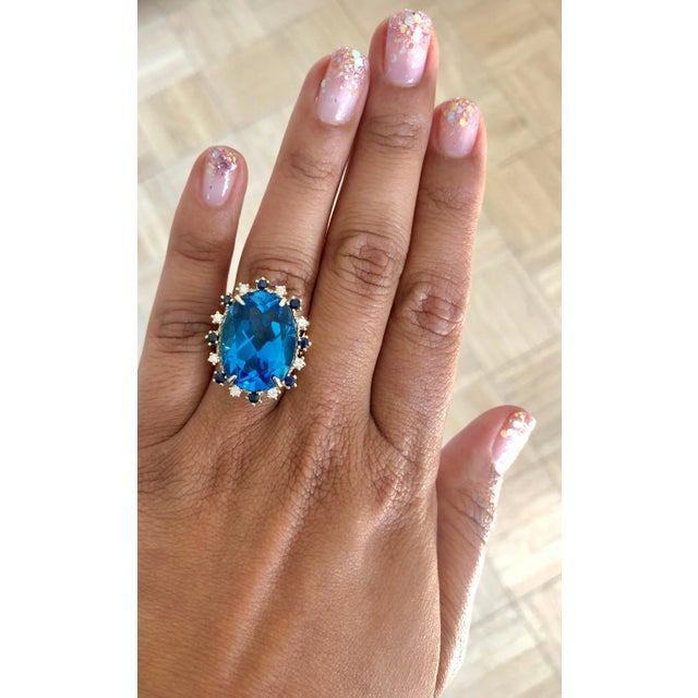 Beautiful to say the Least! This magnificent Oval cut 20.73 Carat Blue Topaz is surrounded by 8 Round Cut Diamonds that...