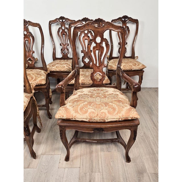 A set of ten Italian fruitwood provincial dining chairs, circa 1920. Eight side chairs, two armchairs. The side chairs...