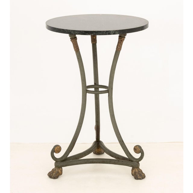 Green Marble Top Painted Metal Gueridon, atop three gilt lion's paw feet. 30" H x 20" Diameter. Provenance: From a 21 East...