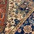 Fine Persian Heriz hand-knotted rug featuring a bold central stepped medallion in deep rust and navy, framed by ivory...