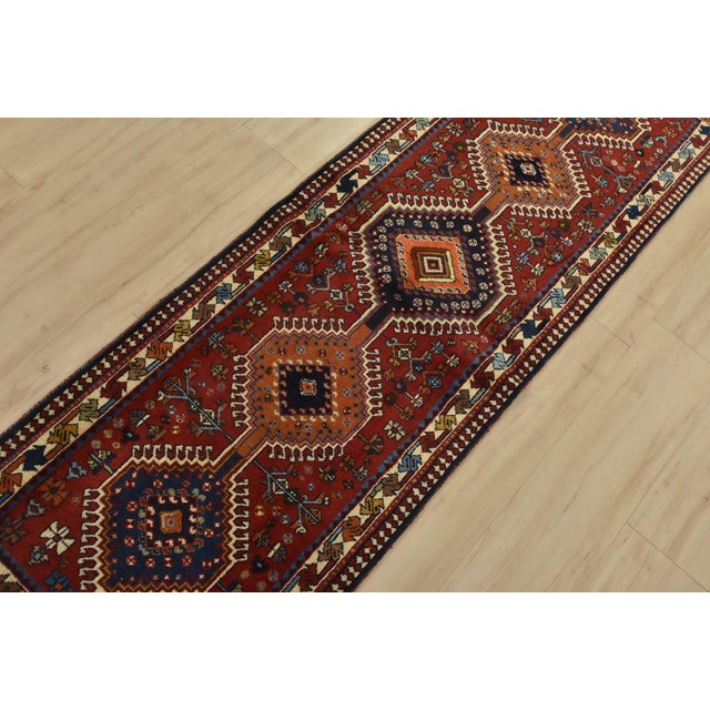 An authentic vintage tribal Yalameh runner hand-knotted with fine wool and natural dyes. This intricately woven rug...