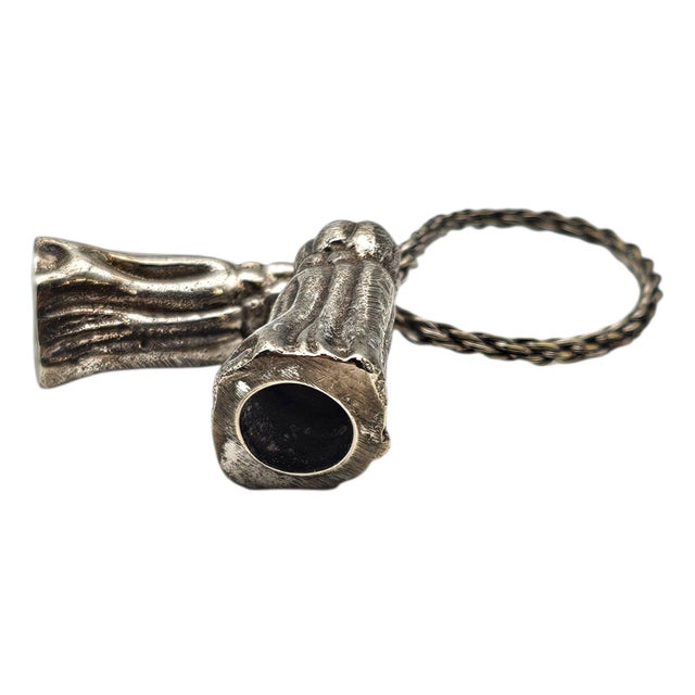 Unusual in their sculptural detail, this set of four silver-plated napkin rings features figural tassel forms that elevate...