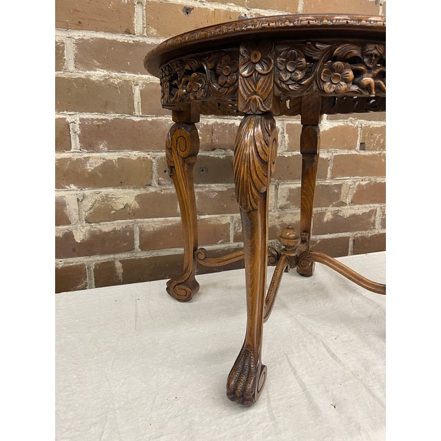 Decorative French Louis XV style accent table complete with glass top. Woven can top and intricately carved apron with...