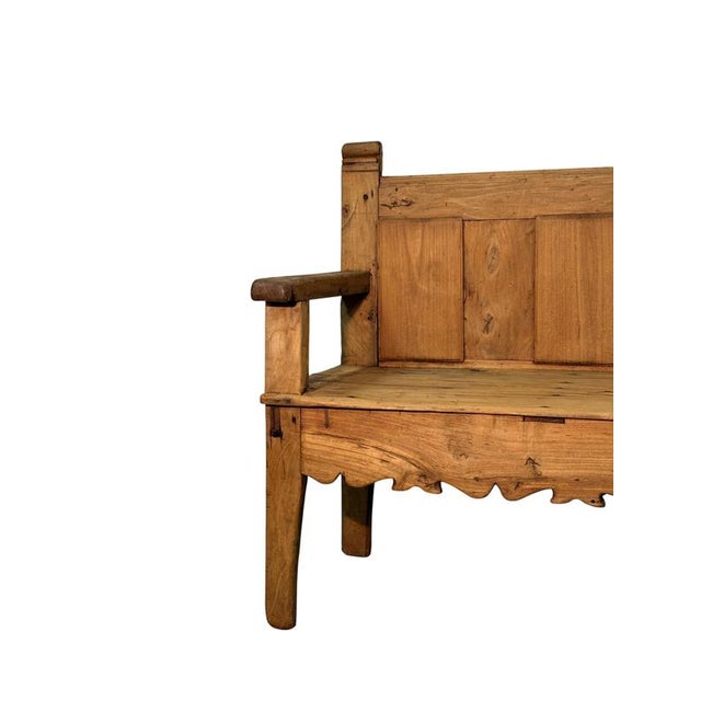 A rustic 19th-century alder wood bench, featuring a simple, sturdy structure that expresses all the charm of traditional...