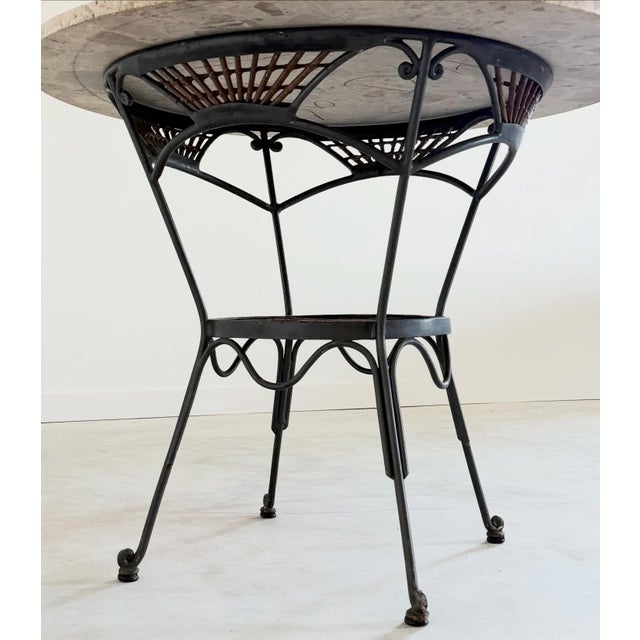 French iron table with a (replacement) Breccia marble top embodies a timeless combination of elegance and durability. The...