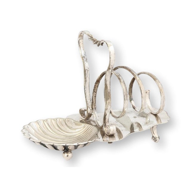 Charming 1930s English silverplate toast rack featuring distinctive spiral toast dividers and an attached shell-form dish...