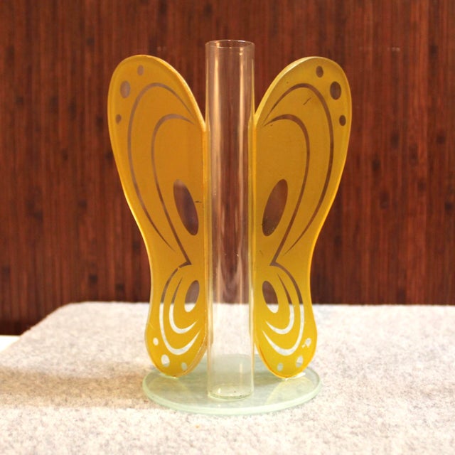 Thin glass bud vase with glass wings detailed with yellow appliqué. Wonderful touch of color for a modern home