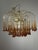 A striking designer chandelier made of Murano glass, created after a 1960s design by Paolo Venini. The brass structure...