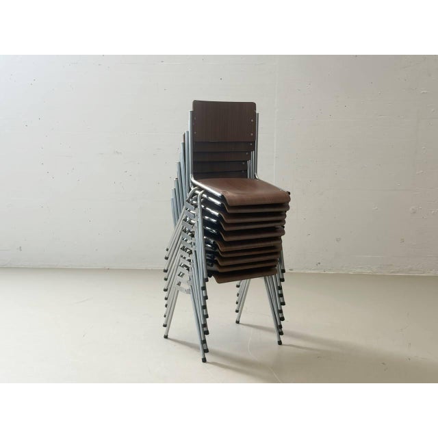 These elegant vintage stacking chairs combine functional industrial design with a warm wood look. The seat and backrest,...