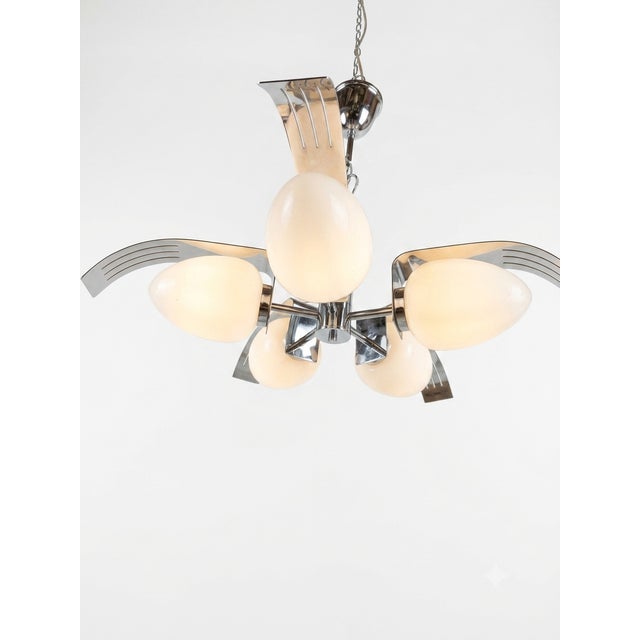 "It stands out due to its unusual, egg-shaped (ovoid) opal glass diffusers, a rare design element for this era." (It...