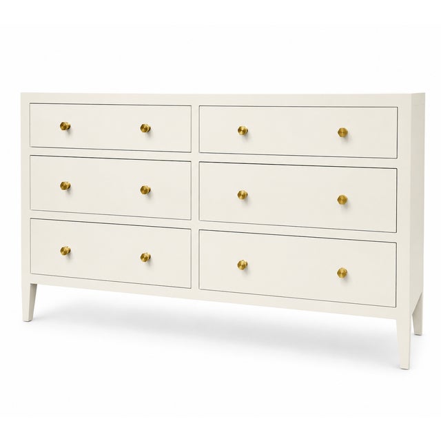 This sophisticated six-drawer dresser by Made Goods is finished in a warm ivory faux Belgian linen finish, creating the...