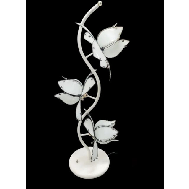 An elegant Hollywood Regency white glass 3 lotus flower table lamp. The lamp is made of white etched glass petals with...