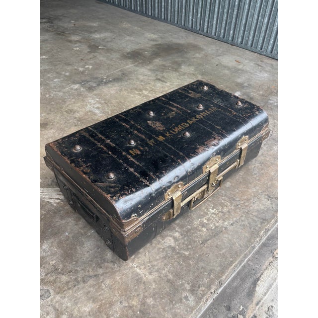 A richly patinated antique steel cabin trunk made in London in the early 20th century, featuring a stamped lock by Short...