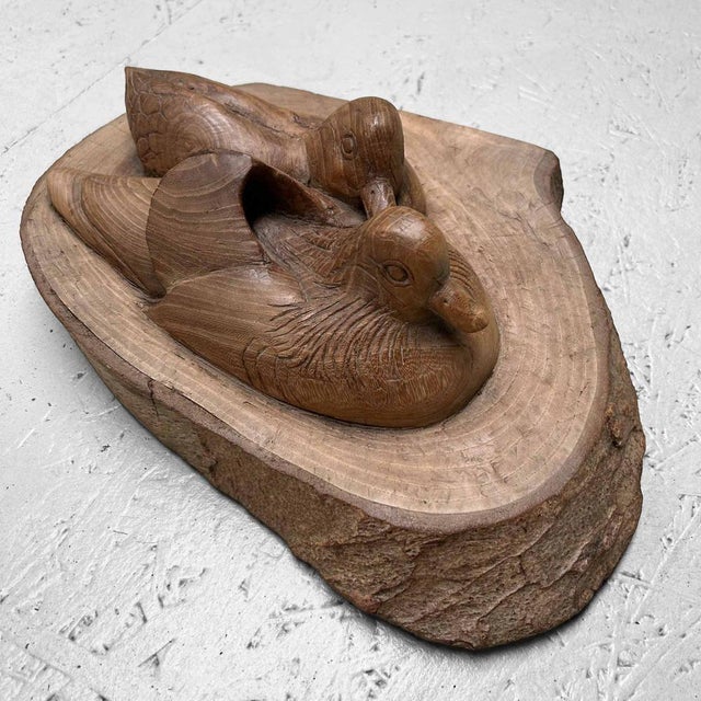 Beautiful Japanese woodcarving depicting a pair of bathing waterfowl from the 1940s-1950s. The artwork is crafted from a...