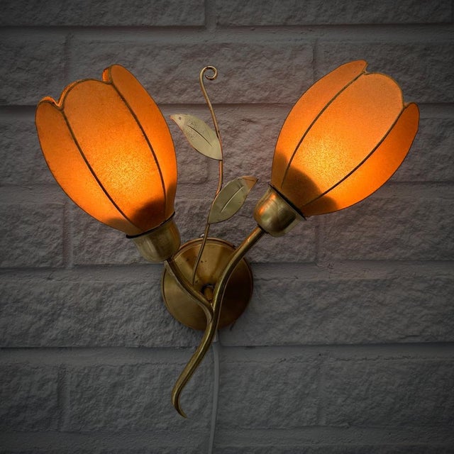 A beautiful Danish Modern wall lamp produced by an unidentified Danish manufacturer in the 1950s. Executed in brass, the...
