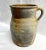 Imported from the Burgundy region of France. Early 1900s rustic hand turned pottery pitcher. Dripped glaze in neutral...