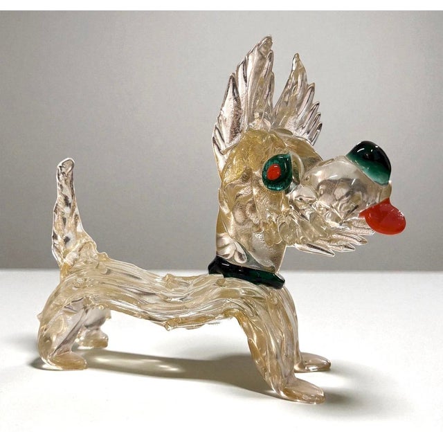 Hand-blown murano glass dog sculpture produced in italy during the 1960s. executed in clear glass with a subtle golden...