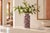 A tall, graceful baluster vase hand-painted in the rich, saturated palette Jaipur is known for: a deep rust-brown ground...
