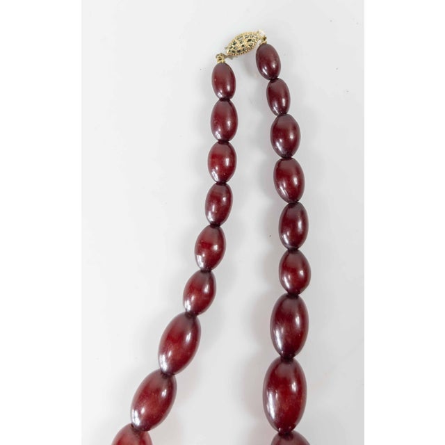 We are selling this nice small Art Deco graduated cherry amber Bakelite bead necklace. The necklace tested positive with...