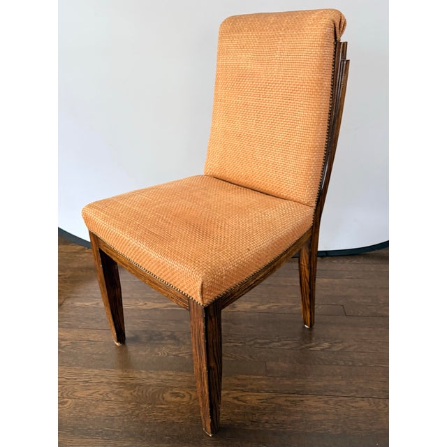 Vintage set of four exquisite woven leather side chairs with richly grained rosewood frames. Their tailored silhouettes...