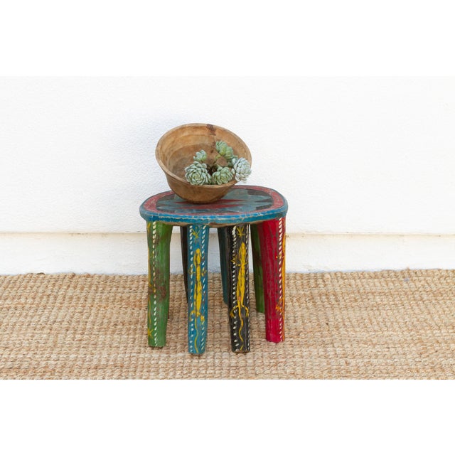 A vibrant and unique piece of African art, this vintage Nupe table from Nigeria is a must-have for collectors and...
