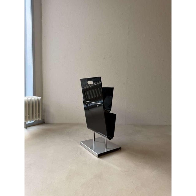 This standing magazine rack is a striking example of minimalist 1980s design. Sourced in Scandinavia, it's crafted from...