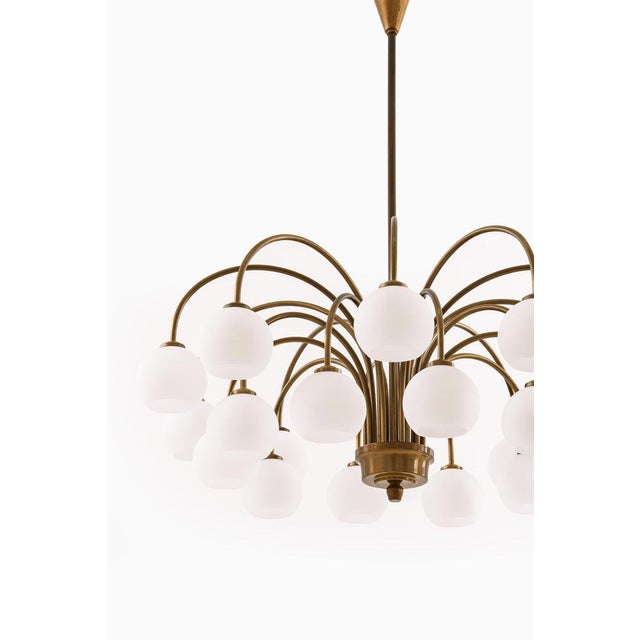 This rare and impressively scaled ceiling lamp, designed and produced by fog & mørup in denmark during the 1940s,...