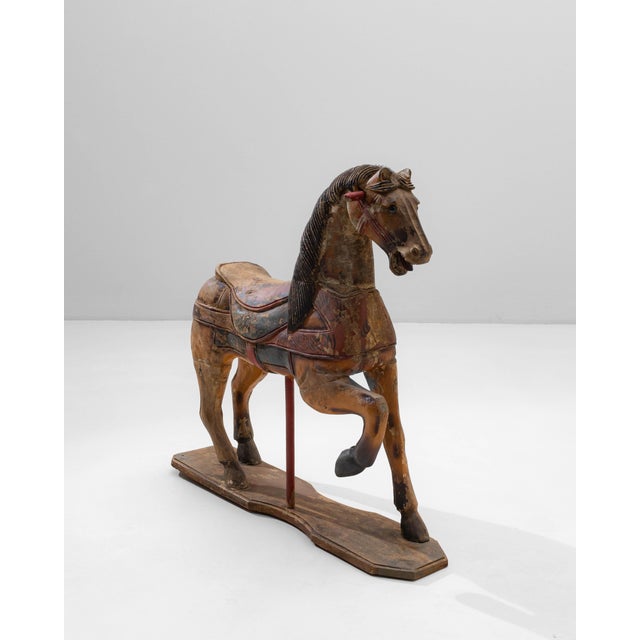 This 1920s French hand-carved wooden carousel horse is a captivating relic of early 20th-century fairground craftsmanship,...