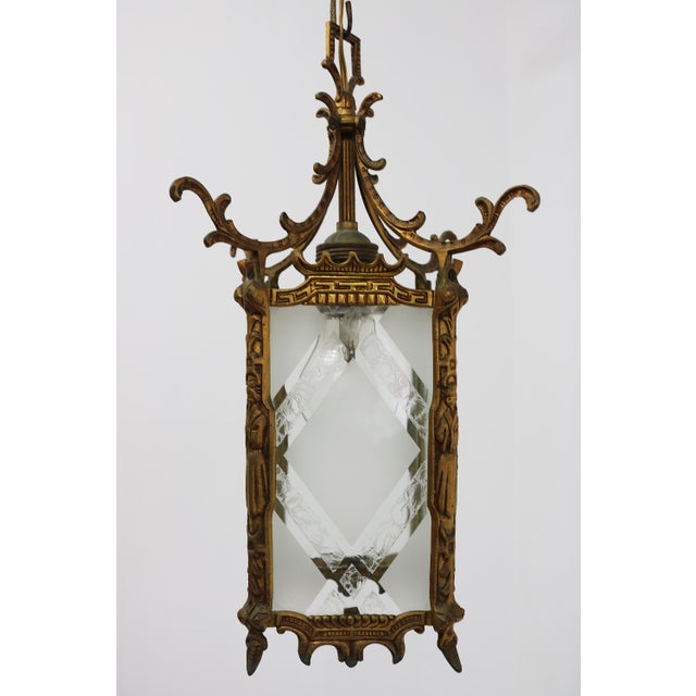 An elegant small antique brass hanging lantern with clear etched glass, dating from the early 20th century (circa...