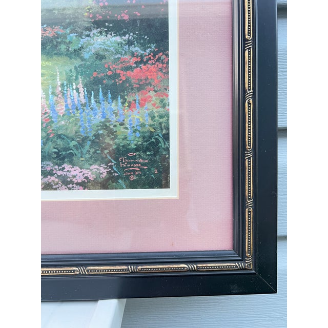Framed "Morning Dogwood" piece by artist Thomas Kinkade. This lithograph features a serene garden scene with a white...