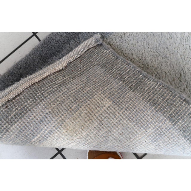 Handmade vintage Persian Gabbeh runner in different shades of grey color. The rug is from the end of 20th century in...