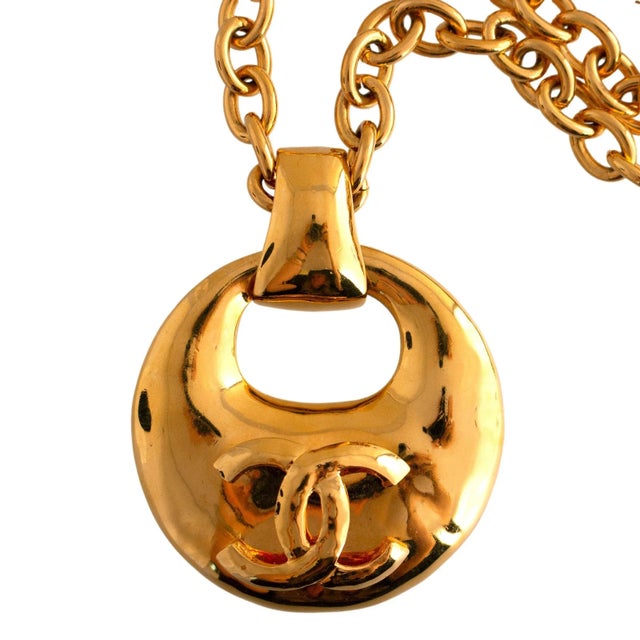 Late 20th Century This pendant necklace is crafted by Chanel. The piece features a bold, circular pendant with an iconic...